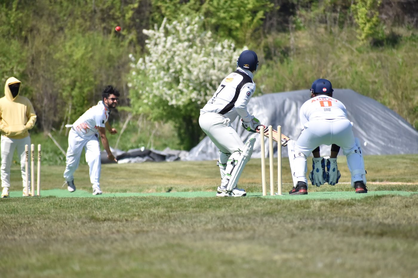Mid-leap in the delivery stride, ball on its way